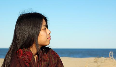 Indigenous girl overlooking water